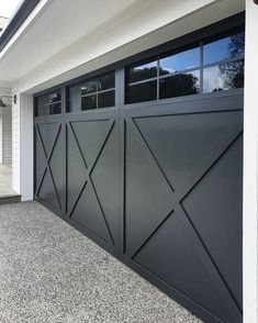 an image of a garage door that is painted black and has white trim on it