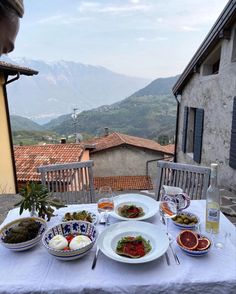 a table topped with plates of food next to a window