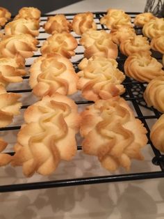 many small pastries are cooling on a rack