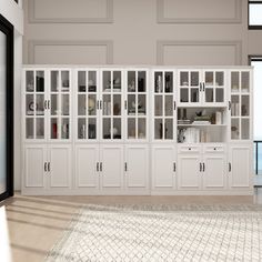 an empty room with white cabinets and glass doors