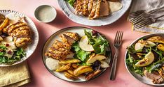 two plates with meat and vegetables on them next to silverware, forks and napkins