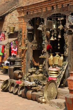 an outdoor market with lots of pots and pans