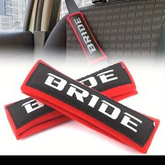 the bride and groom seat belt covers are red, black, and white in color