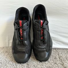 Vintage 2010 Prada "America's Cup" Sneakers. Black Leather Upper/Red Logo + Sole Are In Very Condition With Exception Of Scuffs Shown On Toes. Retailed $895. Business Low-top Sneakers With Red Sole, Prada Shoes Men, Prada Trainers, Prada Sneakers, America's Cup, Vintage Prada, Black Leather Sneakers, Red Logo, Prada Shoes