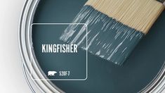 a paint can with the words kingfisher painted on it and a brush inside