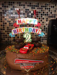 a birthday cake that has cars on it