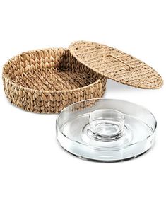 two wicker trays with lids on each one and an empty glass plate in the middle