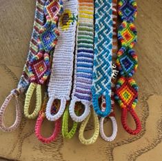 multicolored crocheted scissors are lined up on a table