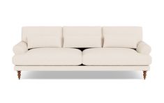 a white couch sitting on top of a wooden frame