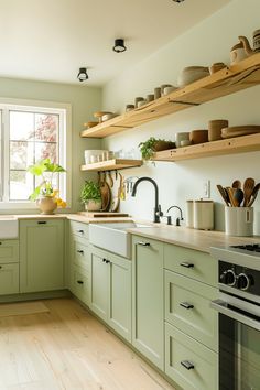 the kitchen is clean and ready for us to use it's green color scheme