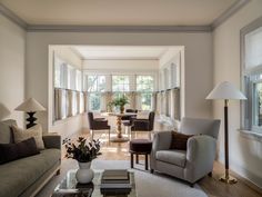 a living room filled with furniture and lots of windows