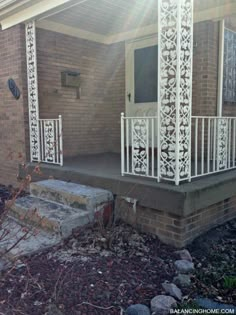 the front porch of a house with white railings