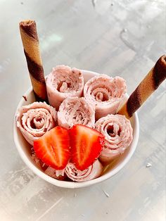 a bowl filled with ice cream and strawberries