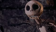 an animated skeleton holding onto a stick in front of a rock wall with spider webs on it