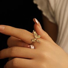 ✦ Indulge in the elegance of our Chunky 18K Gold Butterfly Cocktail Ring made with molten design and 18k gold plating. Perfect for any occasion, this statement ring features a bold butterfly design, adjustable fit, and serves as a luxurious gift for friends. Elevate your style with this exclusive piece that exudes sophistication and uniqueness. ----------- DETAILS ----------- - Color: Gold - Ring Size: 17.3mm (Approximately to Size US7) - Width: 1.8cm - Materials: 18K Gold Plated, Cubic Zirconia Elegant Adjustable Gold Butterfly Ring, Adjustable Gold Butterfly Open Ring, Adjustable Gold Butterfly Ring, Adjustable Yellow Gold Butterfly Ring, Cocktail Rings Statement, Butterfly Cocktail, Elegant Gothic, Nose Rings Hoop, Crystal Hoop Earrings