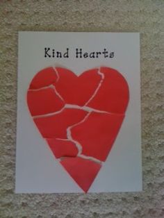 a piece of paper that has been cut into the shape of a heart with words kind hearts written on it