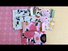 four small wallets with floral designs on them