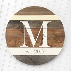 a wooden sign with the letter m on it