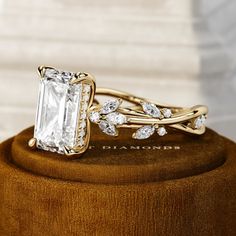 a close up of a ring on top of a wooden box