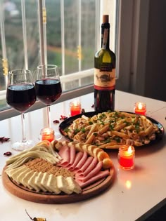 an assortment of food and wine on a table