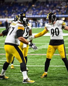 two football players are shaking hands on the field