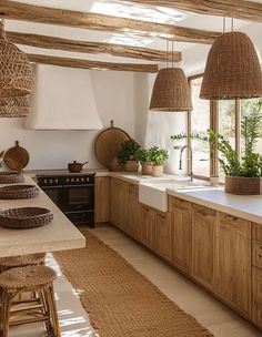 a kitchen filled with lots of counter top space and wooden cabinets next to a window