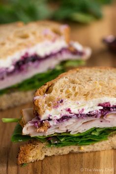 a cut in half sandwich sitting on top of a wooden table