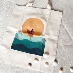 a tote bag with an image of a surfer on it