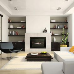 a living room filled with white furniture and a fire place in the middle of it