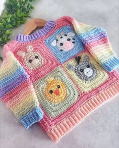 a crocheted sweater with animals on it