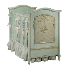 a baby crib with ruffles and bows on it