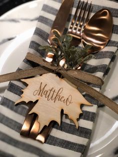 a place setting with silverware and napkins