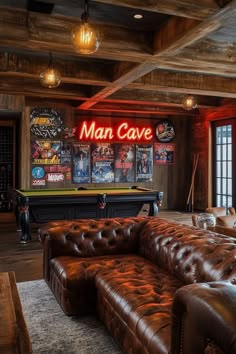 a man cave with leather couches and pool table