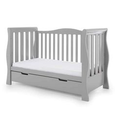 a white crib with a mattress underneath it