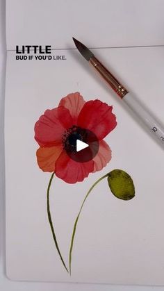 a red flower with green leaves on it next to a white paper and a brush