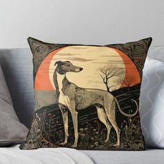 a greyhound dog standing in front of an orange sunset throw pillow