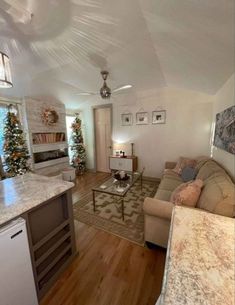 a living room filled with furniture next to a kitchen