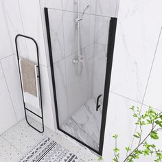 a white tiled bathroom with black trim and glass shower door, rugs on the floor