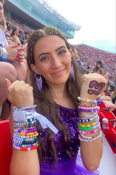 a woman wearing bracelets at a baseball game