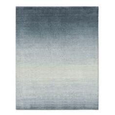 an area rug with blue and white ombrettas on the bottom, in shades of