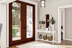 a white table sitting next to a wooden door in a room with hardwood flooring