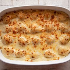 a casserole dish filled with chicken and cheese