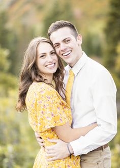 a young man and woman hugging each other