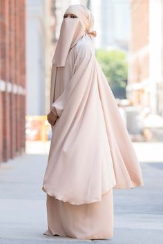 Light up the day as pretty as ever in our Mahasen Jilbab Set in Arabian Sand. The lightweight, ultra-smooth Nida fabric is perfect for keeping you looking modest and feeling comfortable in any weather. Made with silky smooth Nida 3-Piece Set includes the Jilbab, Skirt (elastic waist), and Niqab Jilbab is free size with adjustable skirt length Made in Dubai Adjustable Skirt, Niqab, Muslim Women, In Dubai, Skirt Length, One Size Fits All, Free Size, 3 Piece, Light Up