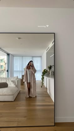 a woman taking a selfie in front of a mirror