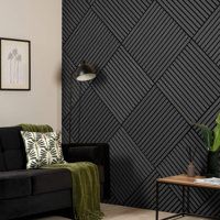 a living room with black and white wallpaper, green throw pillows and a coffee table