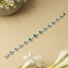 This stunning tennis bracelet is beautifully crafted with vibrant emerald green/ sapphire blue cubic zirconia stones, each meticulously set within a halo of sparkling white CZs. The silver-tone base adds a touch of elegance and durability, making this piece perfect for adding a pop of color to any outfit. Ideal for those seeking a touch of luxury at an affordable price, this bracelet is a must-have accessory for both casual and formal occasions. Enhance your jewelry collection with this exquisite blend of style and sophistication. Guaranteed to arrive looking even more stunning than it does on your computer screen, our jewelry is crafted to impress. **WHY CUBIC ZIRCONIA? Unlike diamonds, cubic zirconia is always flawless. It is a fantastic ethical and cost-effective alternative to diamonds Elegant Green Oval Diamond Bracelet, Luxury Green Oval Tennis Bracelet, Green Oval Diamond Bracelets, Oval Emerald Bracelets For Anniversary, Oval Green Diamond Bracelets, Green Oval Diamond Tennis Bracelet, Green Oval Diamond Bracelet For Anniversary, Fine Jewelry Green Oval Bracelets, Oval Green Bracelets Fine Jewelry