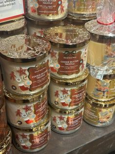 many tins of candles are on display