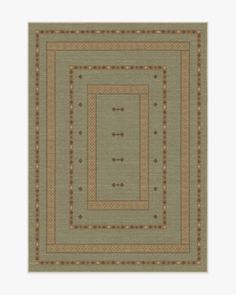 a green rug with brown and tan designs on it's border, in the middle of