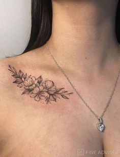 a woman's chest with flowers and leaves tattoo on her left side ribcage